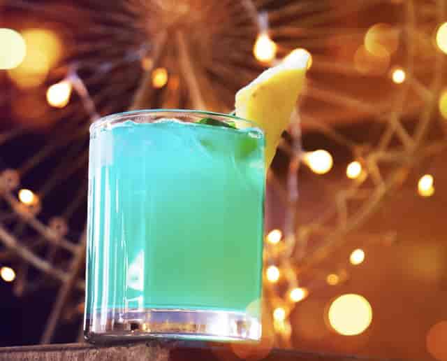 Alchemist Rooftop evening reception with branded cocktail bar for corporate events.