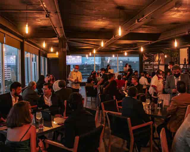 Networking reception at XKINA rooftop bar with city skyline views for corporate events.