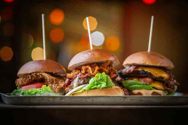 Three Brothers Burgers skewers on a rustic tray for casual catering and networking lunch events.