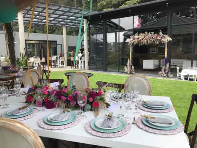 Elegant banquet hall with floral centerpieces, perfect for garden party and wedding reception venue.