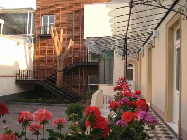 Boutique courtyard venue with central staircase for intimate wedding or event reception.