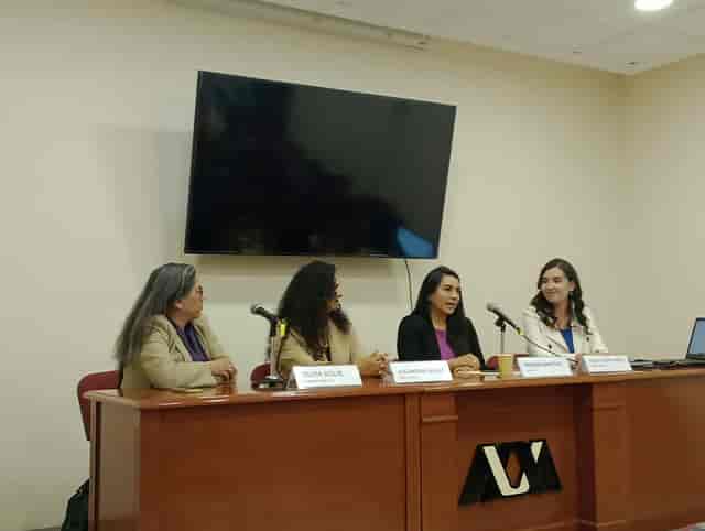 Four-person panel discussion at Casa Rafael Galván, professional conference event setup.