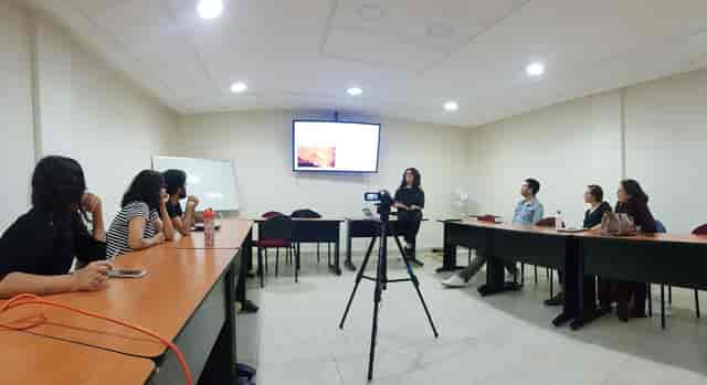 Workshop meeting setup at Casa Rafael Galván with classroom seating and AV equipment.