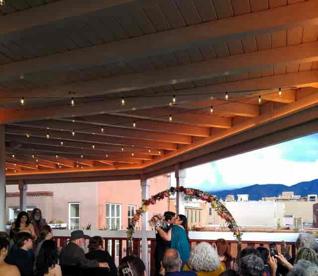 Sunset Terrace lounge with string lights for intimate mountain wedding ceremony venue.