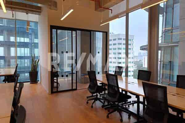 Minimalist private boardroom with natural light for team strategy sessions and corporate meetings.