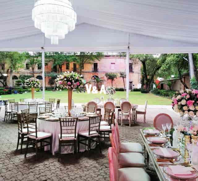 Outdoor gala banquet hall with floral tablescapes for luxury wedding and corporate event venue.