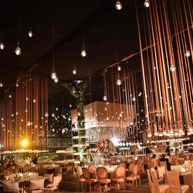 Cascading ribbon ceiling installation with Edison lights for luxury wedding or gala event design.
