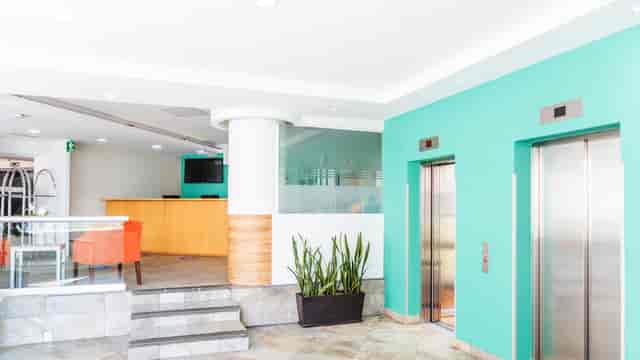 Modern hotel lobby at Gamma Santa Fe with reception desk for event registration and corporate events.