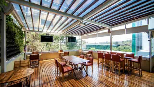 Sala De Consejo breakout space with high-top seating for corporate events and networking.