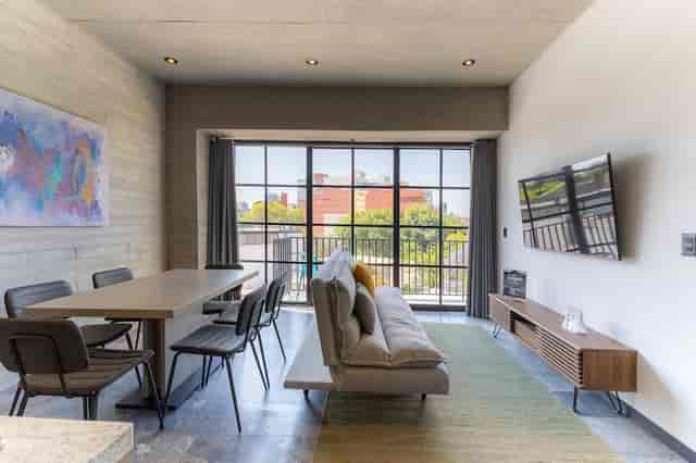 Cozy 1BR terrace nook: VIP green room or meeting space for corporate events and workshops.