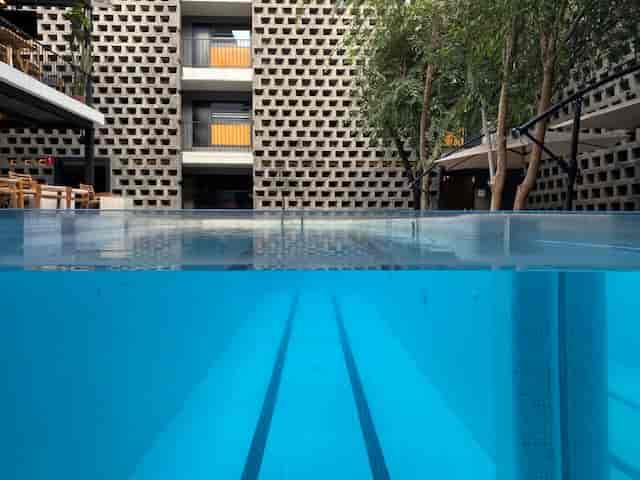 Hotel Carlota pool bar, architectural backdrop, ideal for luxury incentive retreats and receptions.