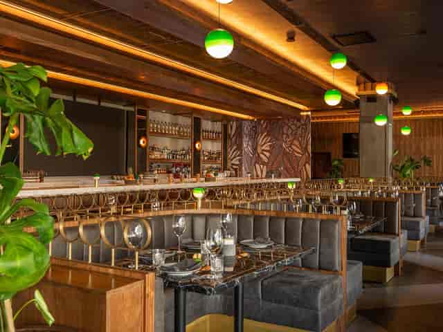 Sophisticated restaurant with tiered booth seating for corporate dinners and networking events.