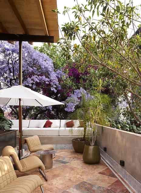 Hotel Dama rooftop terrace with plush lounge seating for networking events and creative meetings.