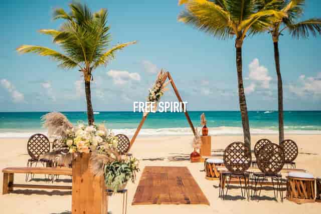 Boho-chic beach wedding at Fania Ballroom with triangular arch for destination event inspiration.