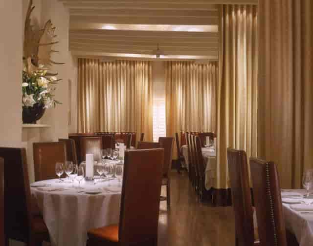 Formal dining room at Geronimo with floor-to-ceiling drapery for VIP board meetings and events.