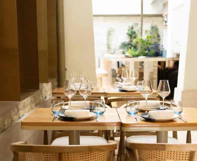 Aquiles Restaurant: Intimate dining space with natural light for VIP luncheons and private events.