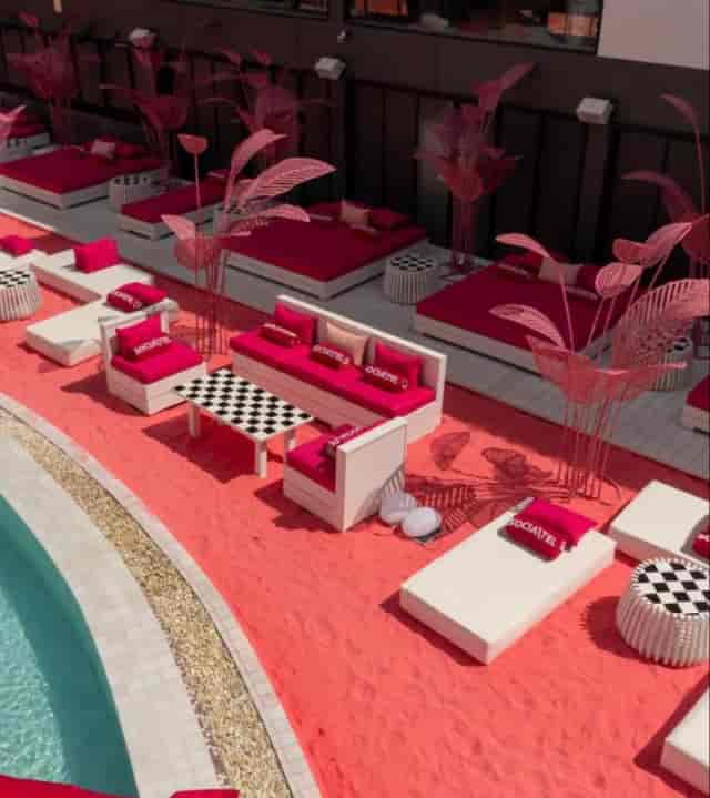 Vibrant Socialtel poolside lounge with checkerboard accents for VIP outdoor events.