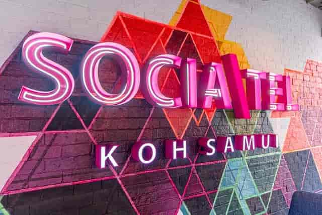 Socialtel lounge with branded accent wall for event photography and corporate backdrop.
