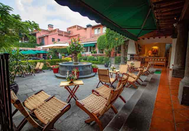 Corporate event space in Las Mañanitas with rattan seating for cocktail receptions or breakouts.