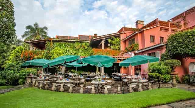 Las Mañanitas garden dining area for outdoor wedding reception or corporate luncheon event space.