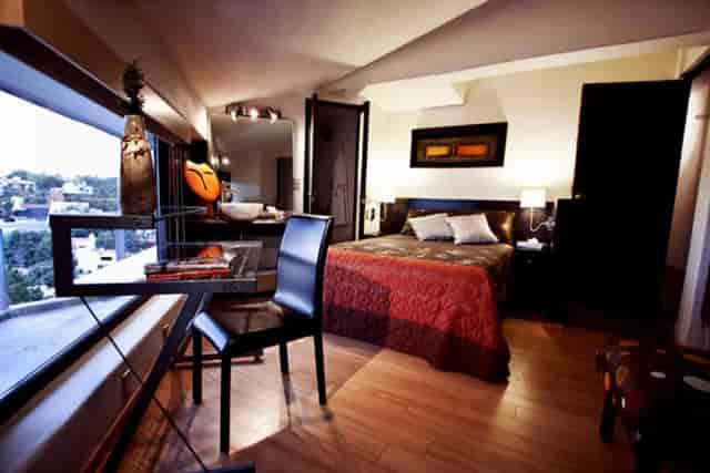 Modern Executive Suite hotel room with workstation for business travel and corporate events.