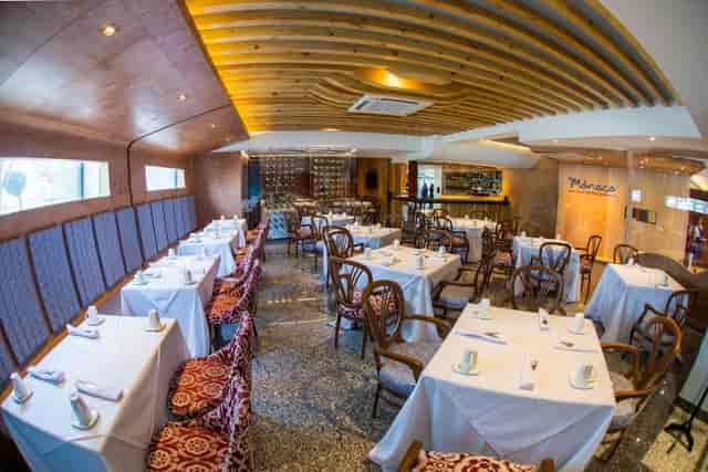 Formal corporate dinner setup with textured ceiling at Grand Prix Hotel event venue.