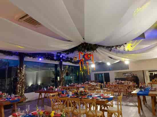 Terraza La Plaza banquet hall with rustic tables and piñata for festive event venue celebration.