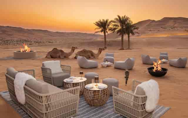 Luxury desert dining setup with fire pits for experiential corporate incentive events.