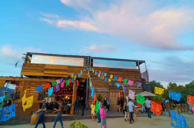 Rustic wine bar at Casa Frida with papel picado, ideal for networking mixers and welcome receptions.