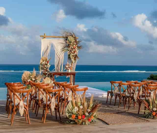 Bohemian wedding altar at Kalan Board Room, The Fives Oceanfront with ocean view for destination events.