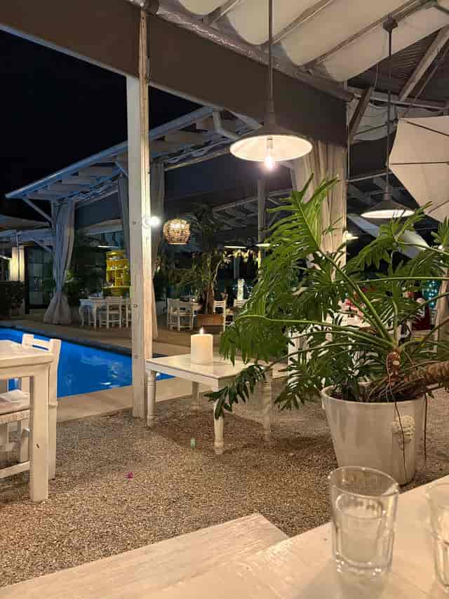 Poolside garden event venue at Las Casas Hotel with warm lighting, perfect for intimate receptions.