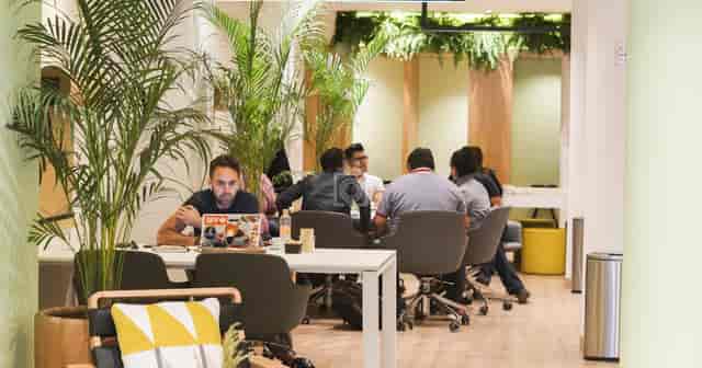 Modern biophilic meeting room for agile team huddles and coworking breakout sessions.