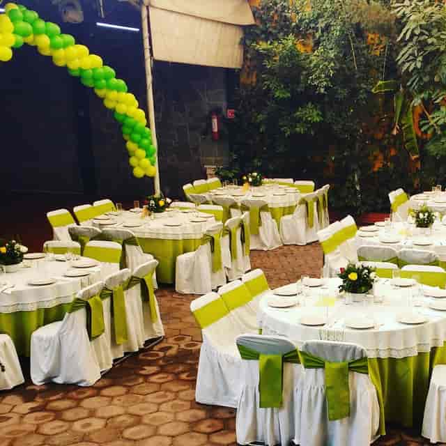 Lime and white banquet hall, balloon arch decor for casual event or party venue.