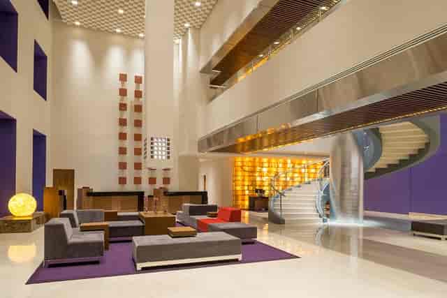 Contemporary hotel atrium, stylish event space, corporate gathering and conference venue.