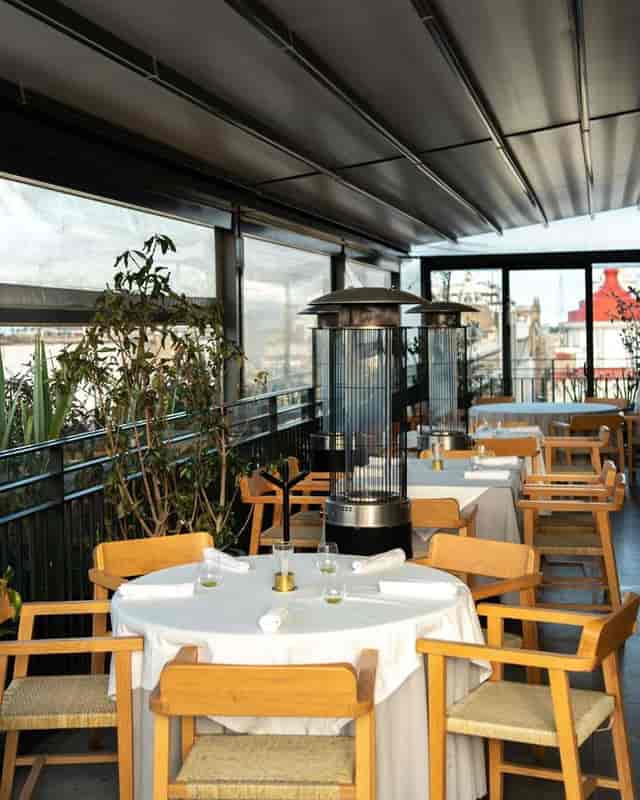 Modern rooftop cinema event space with chic decor for intimate dining and networking.