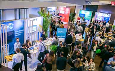 Tradeshow booths at Maison de la Mutualité with branded displays for business networking event.
