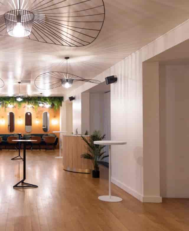 Modern versatile workstation space with warm lighting for networking events.