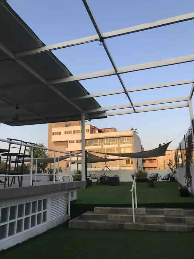 Industrial rooftop venue with outdoor seating for corporate networking and cocktail events.