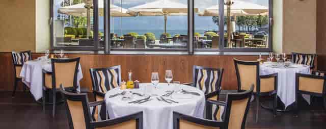 Luxury waterfront dining lounge at Hôtel Angleterre for executive retreats and client lunches.