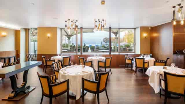 La Côte waterfront dining room with circular tables for professional events and meetings.
