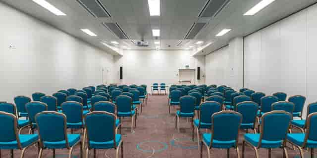 Theater-style auditorium at Aquatis Hotel for corporate presentations and business events.