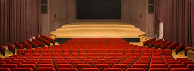Salle Paderewski auditorium with red seating for keynote presentations and panel discussions.