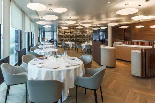 Upscale cocktail bar with floor-to-ceiling wine storage for corporate dinners and board retreats.