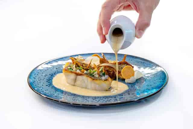Plated dinner service at Ballroom L'Espace with tableside pouring for gala events.