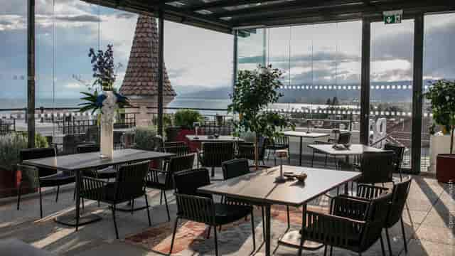 Sky Lounge rooftop terrace with minimalist furniture for executive lunches and cocktail events.