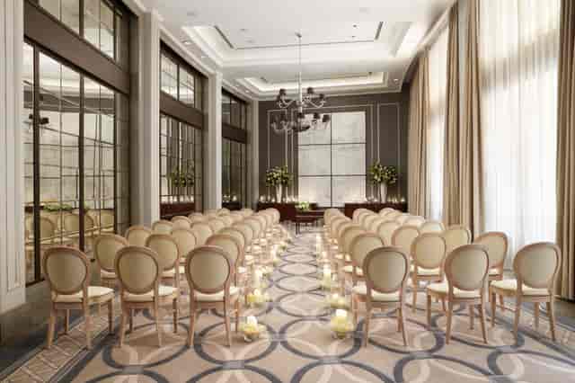 Elegant wedding setup with floral arrangements at Corinthia London event space.