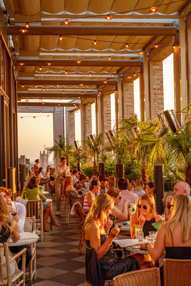 Lively rooftop dining at Seabird, ideal for summer networking events and gatherings.