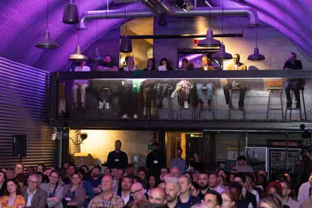 Dynamic event space at Mamuśka! with engaged audience and ambient lighting.