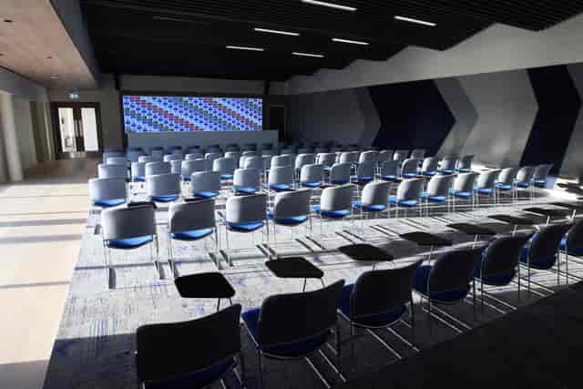 Tiered theater-style conference room for corporate events and professional meetings.
