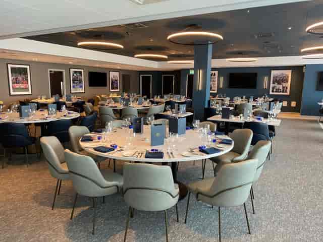 Hospitality suite with circular dining setup for corporate events and private banquets.